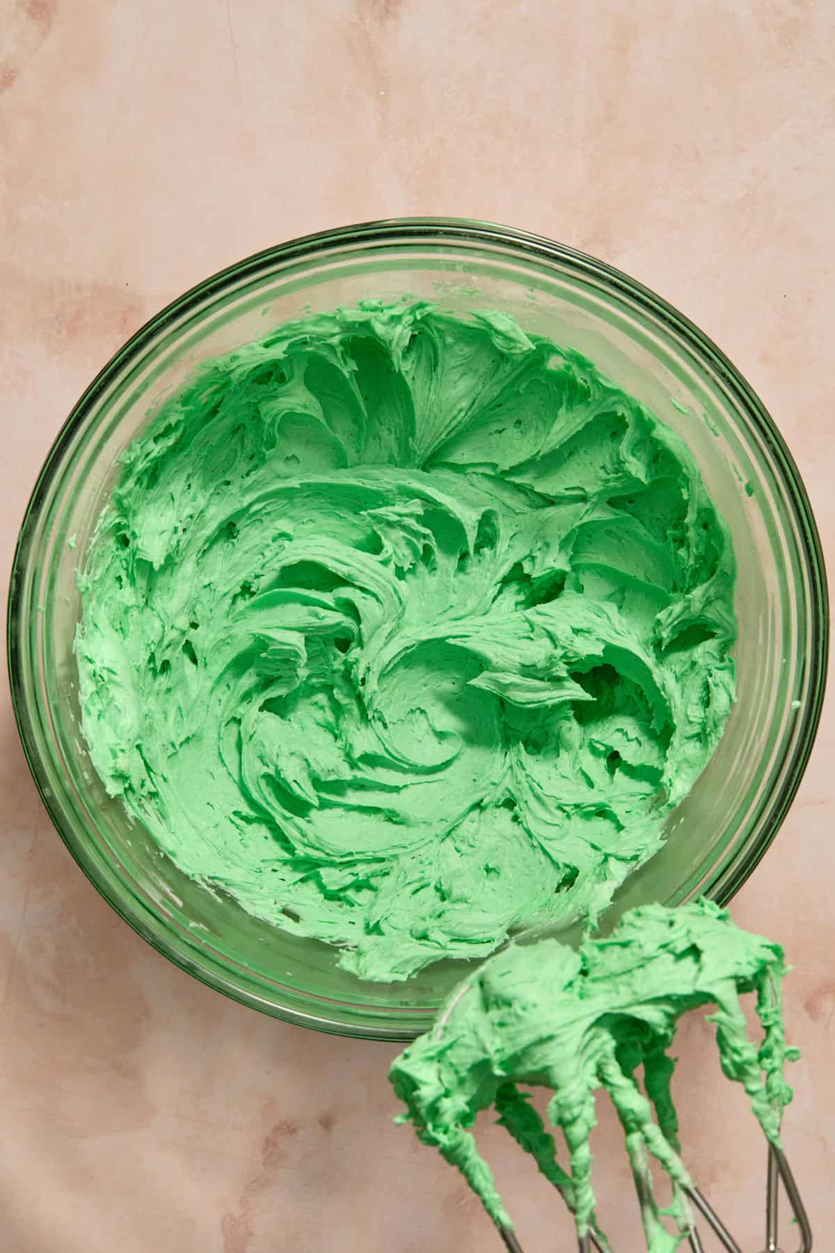 Green buttercream in mixing bowl.