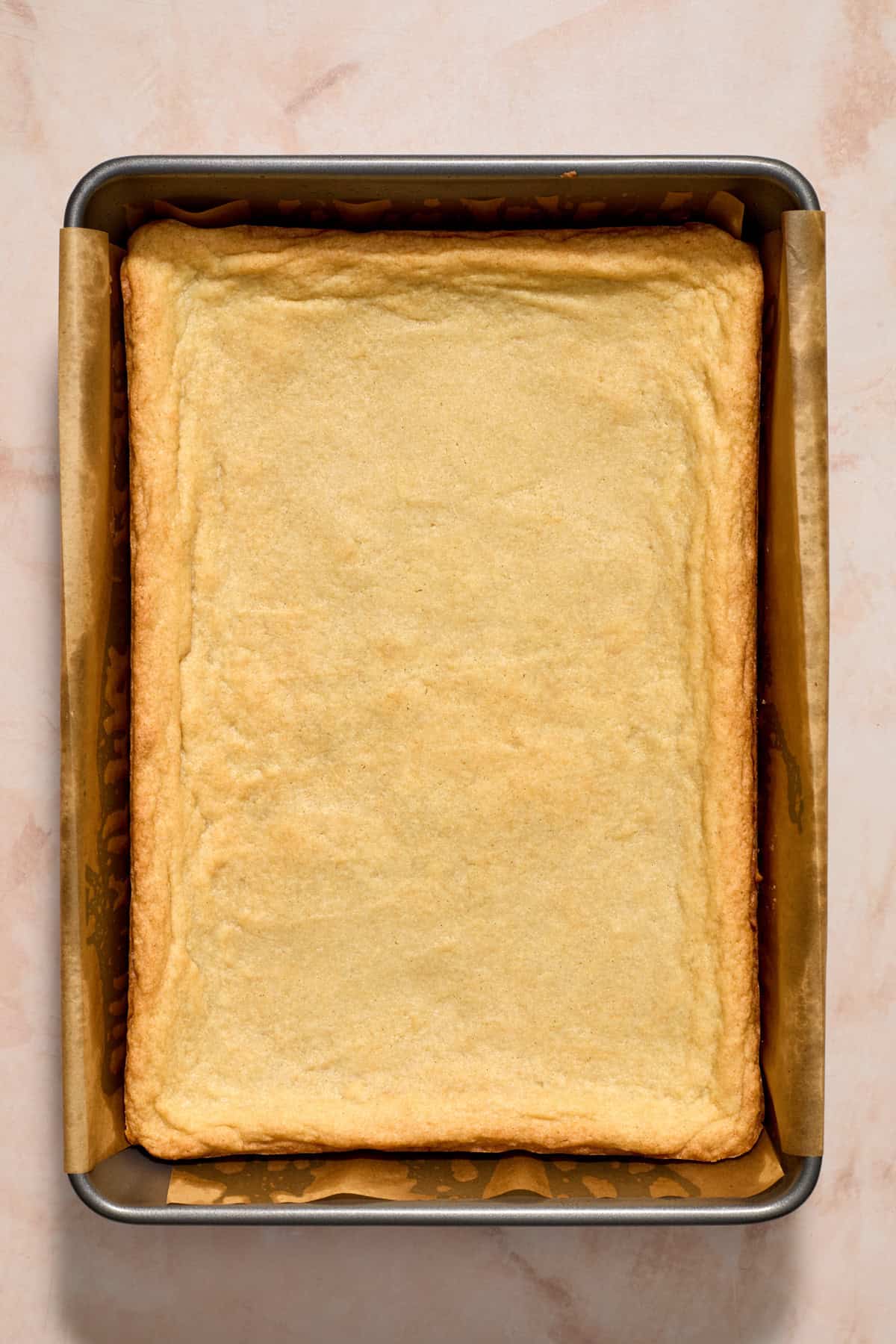 Cooked sugar cookie bar in pan.