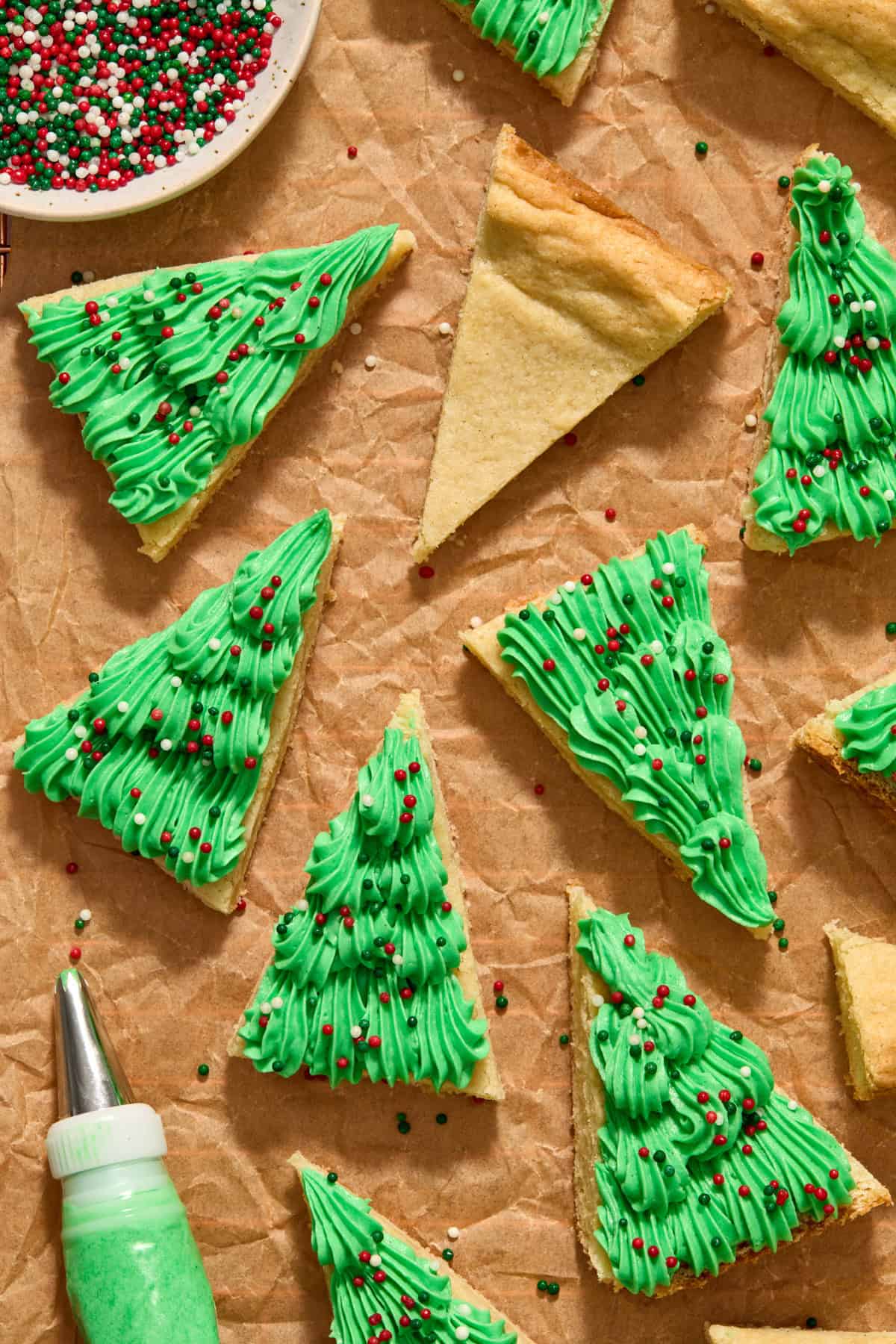 Frosted Christmas sugar cookie bars on parchment.