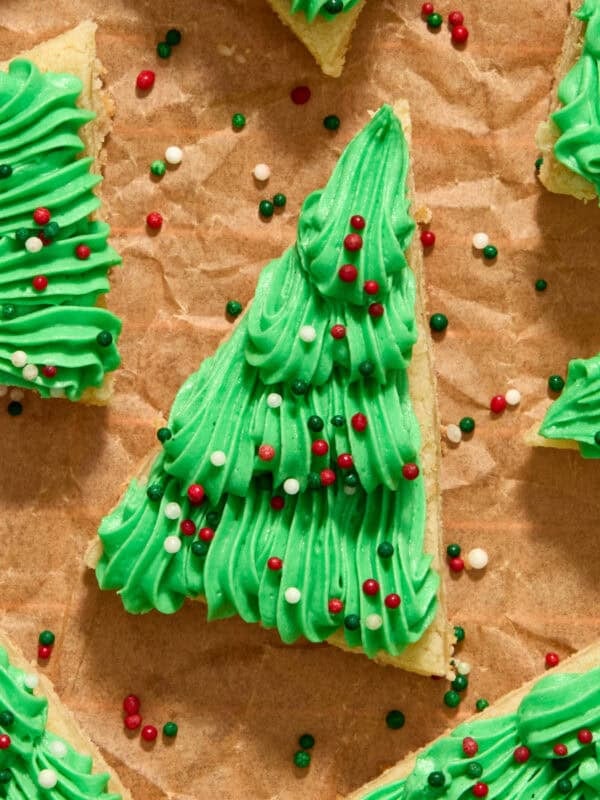 Frosted Christmas tree sugar cookie bars with red, green and white sprinkles.