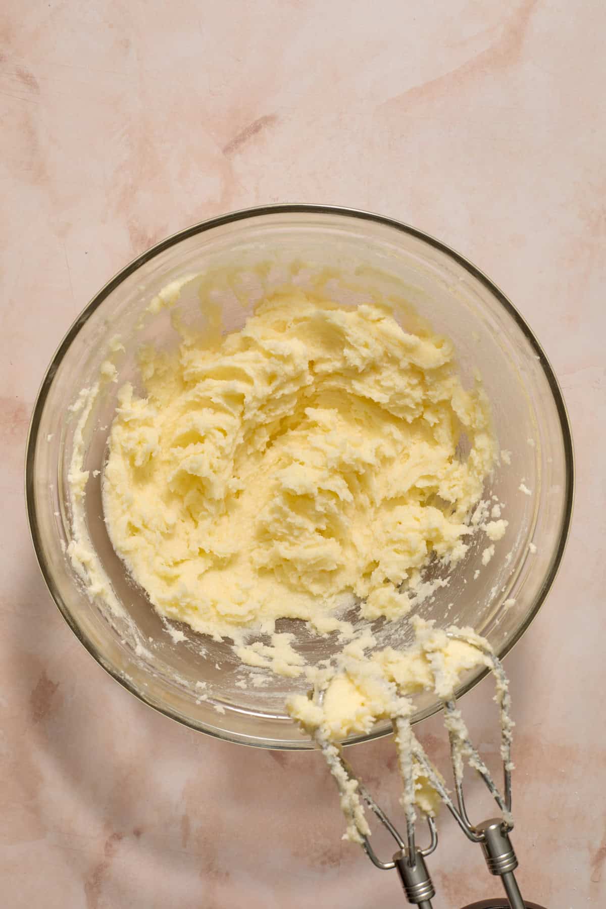 Butter and sugar creamed together in bowl.