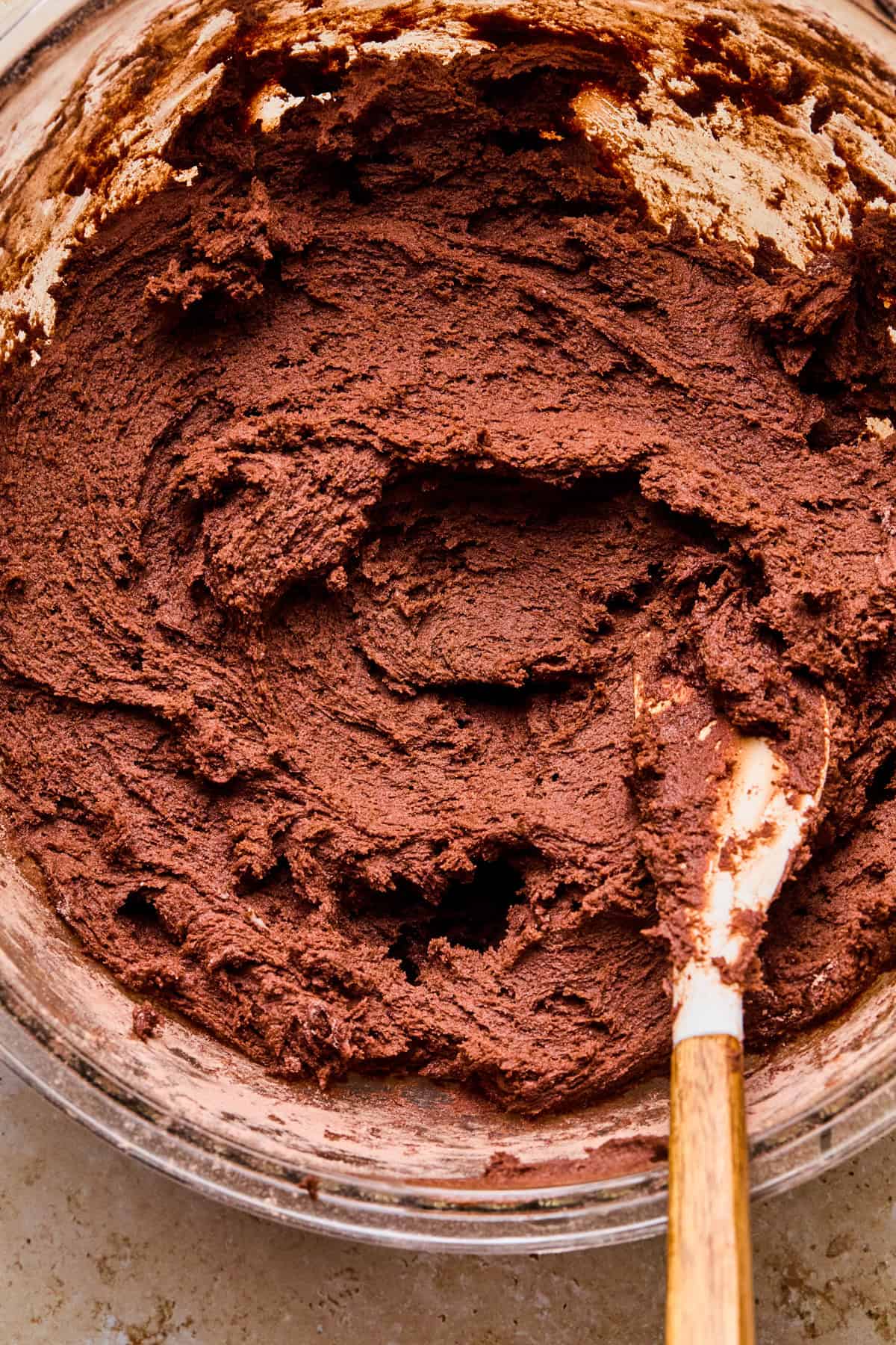 Cosmic brownie cookie dough in bowl with spatula.