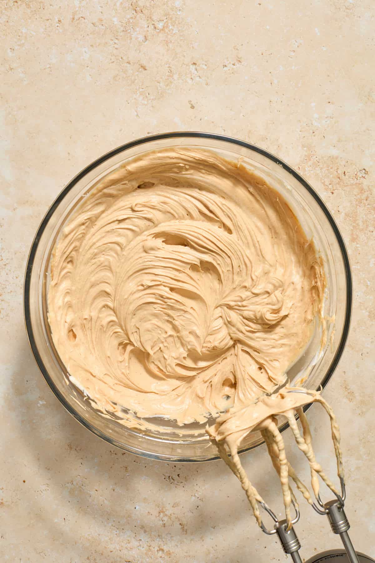 Mixed cookie butter cheesecake mixture in bowl.