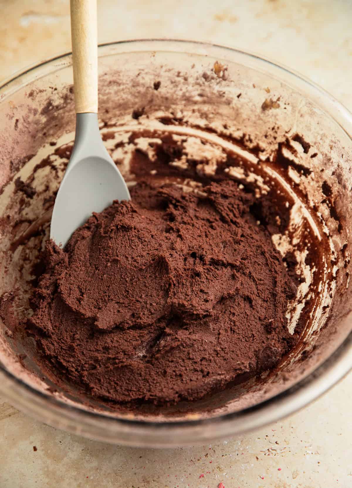 Peppermint mocha cookie dough in bowl with spatula.