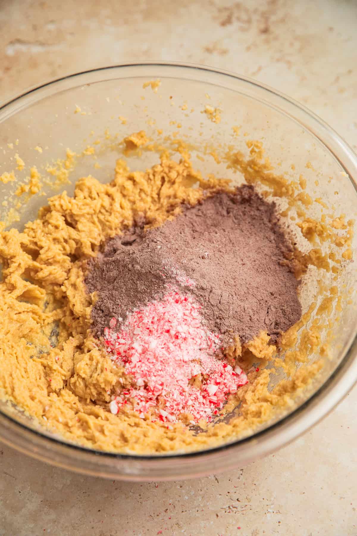 Dry ingredients and crushed candy canes added to bowl with wet ingredients.