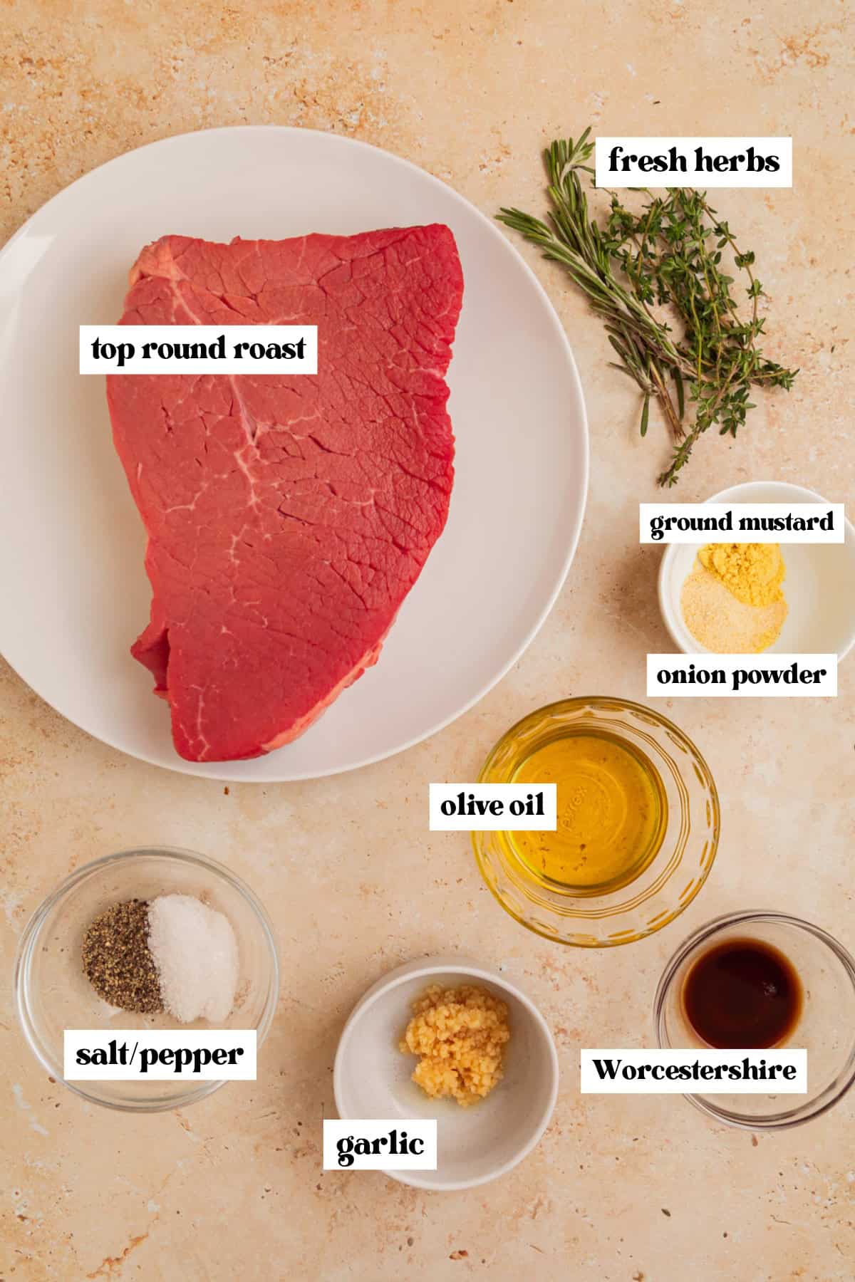 Cut of top round, olive oil, herbs and other ingredients for recipe.