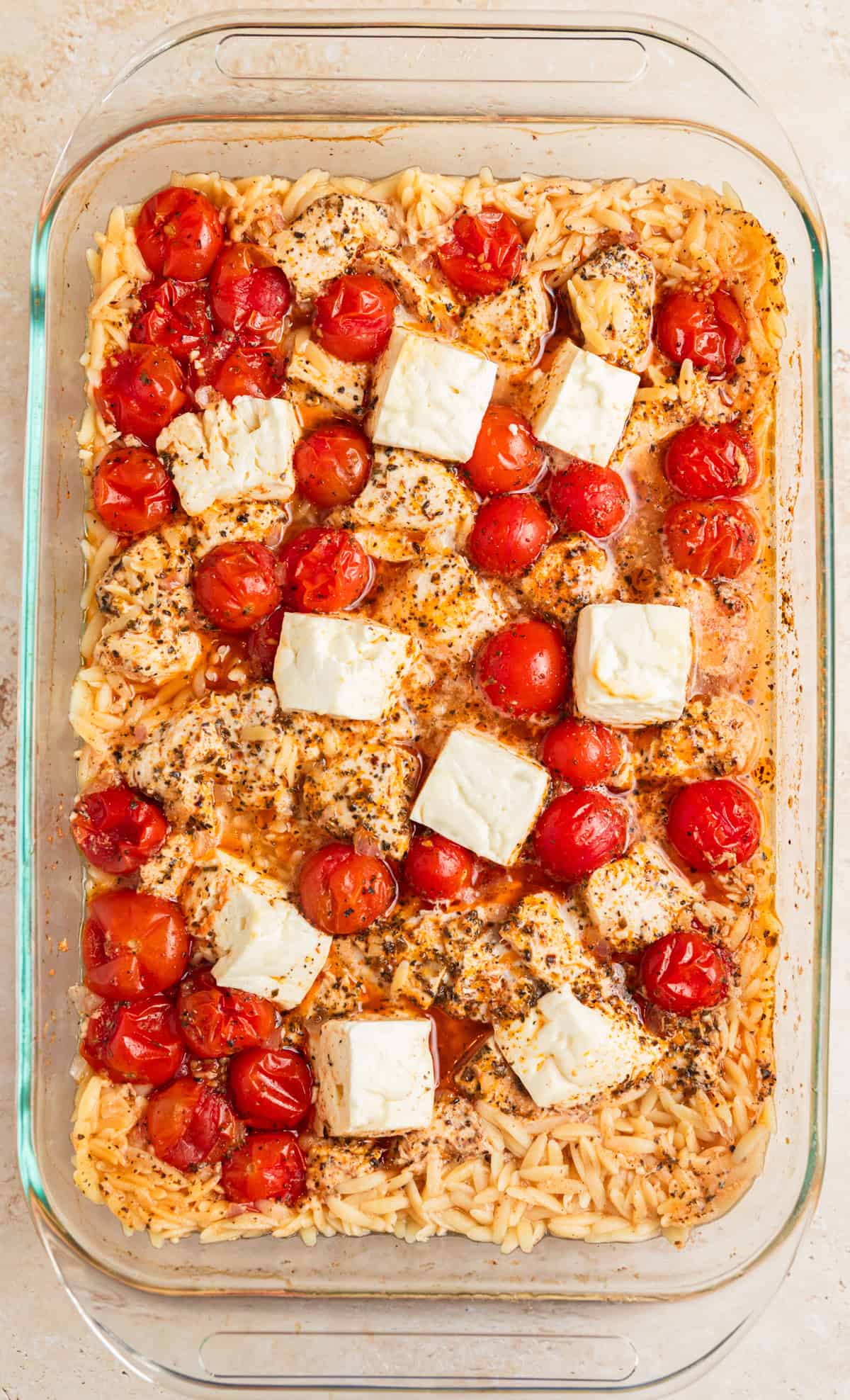 Baked chicken, orzo and feta in pan.