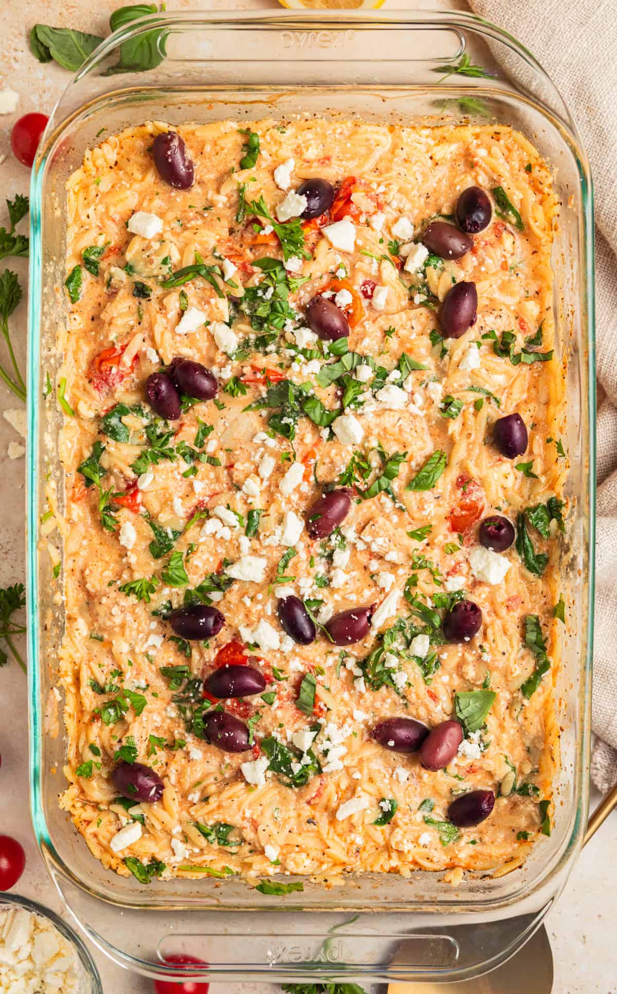 Baked Greek chicken and orzo with feta, olives and parsley over top.