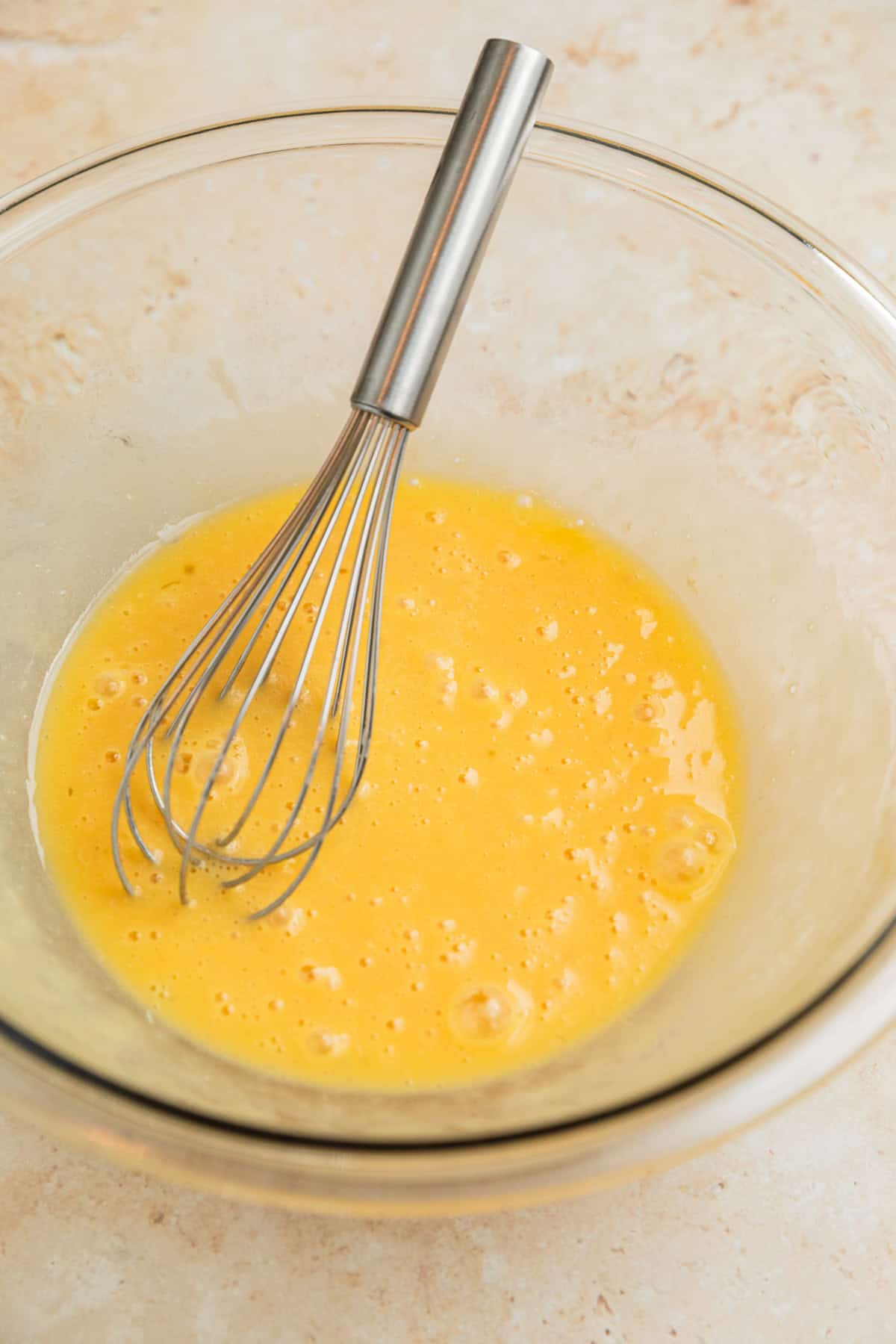 Melted butter, egg and vanilla whisked in bowl.