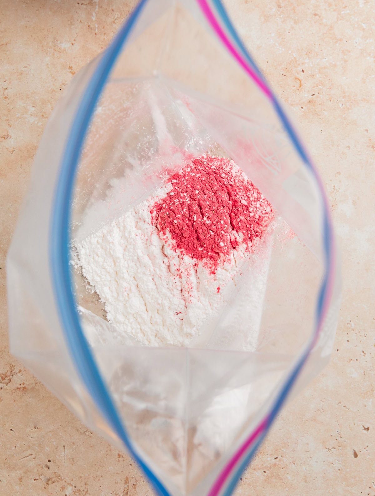 Ziplock bag with powdered sugar and strawberry powder.