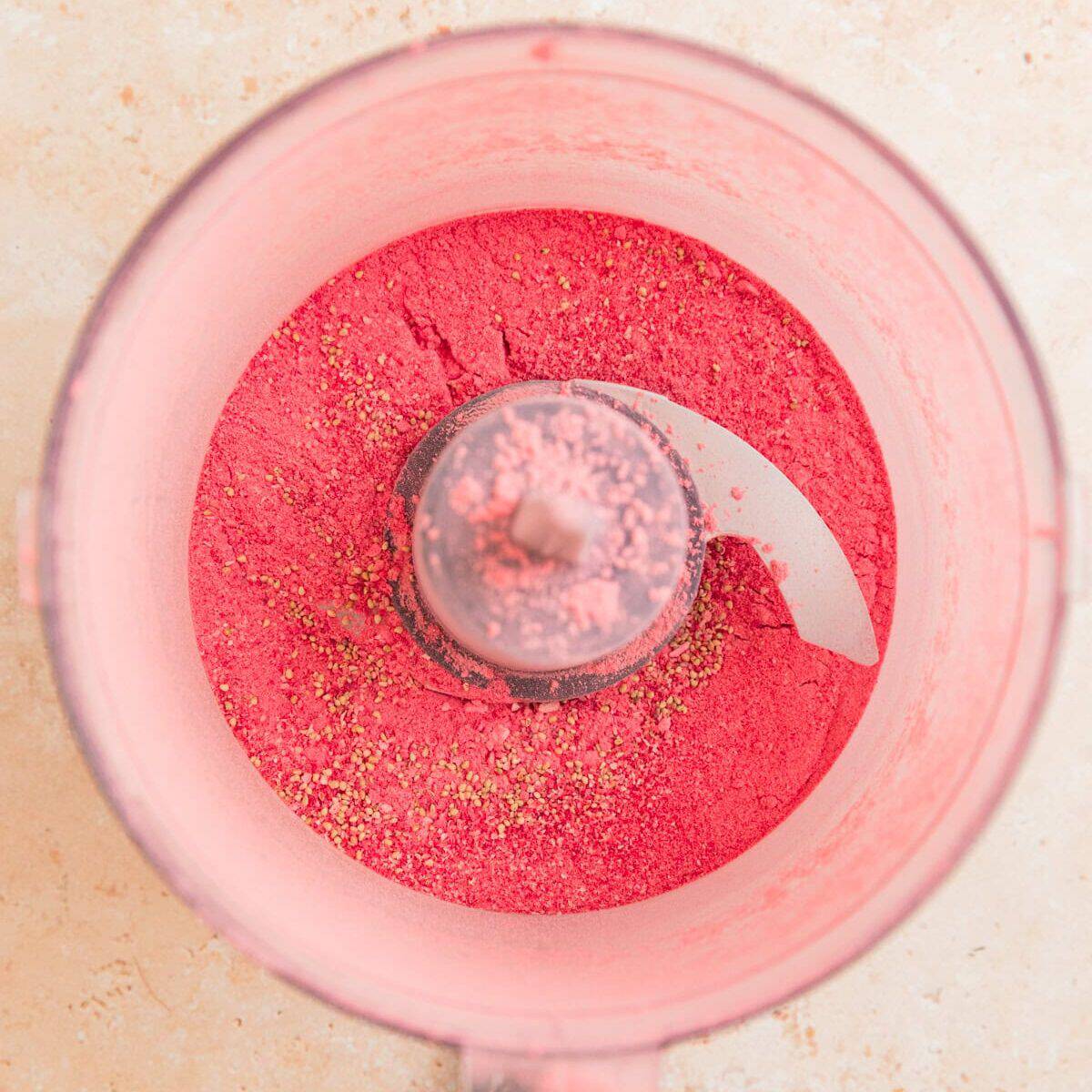Freeze-dried strawberries in food processor made into powder.