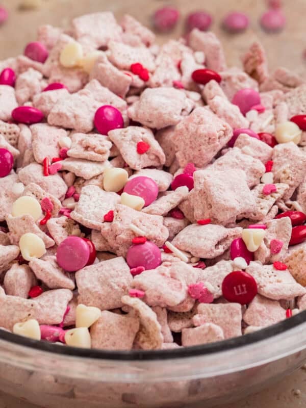 Glass bowl with strawberry puppy chow snack.