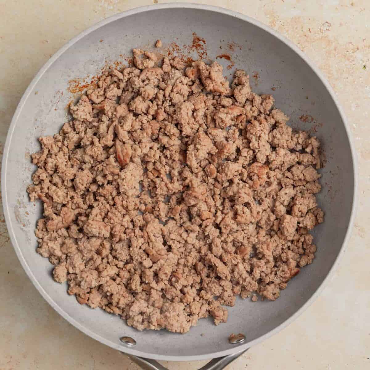 Browned ground turkey in skillet.