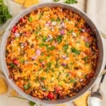 Cheesy taco and rice skillet dinner in pan.