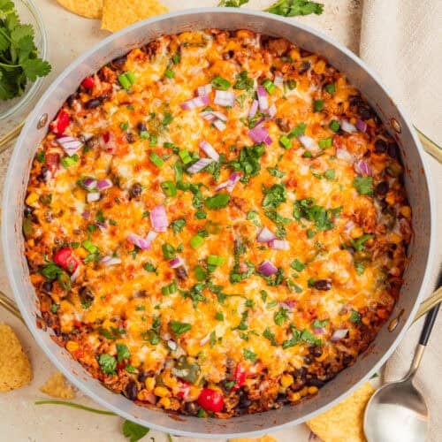 Cheesy taco and rice skillet dinner in pan.