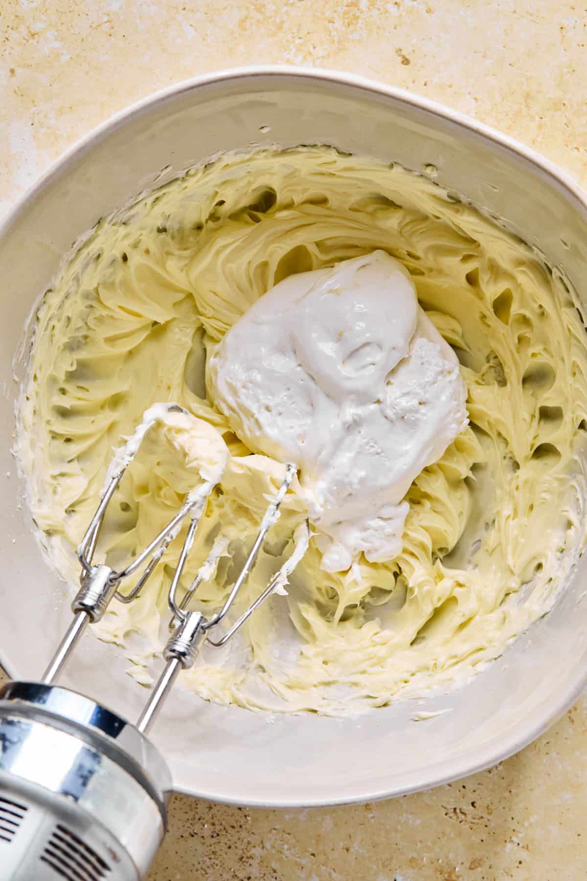 Cream cheese, powdered sugar and vanilla whipped together with marshmallow cream spooned over top.