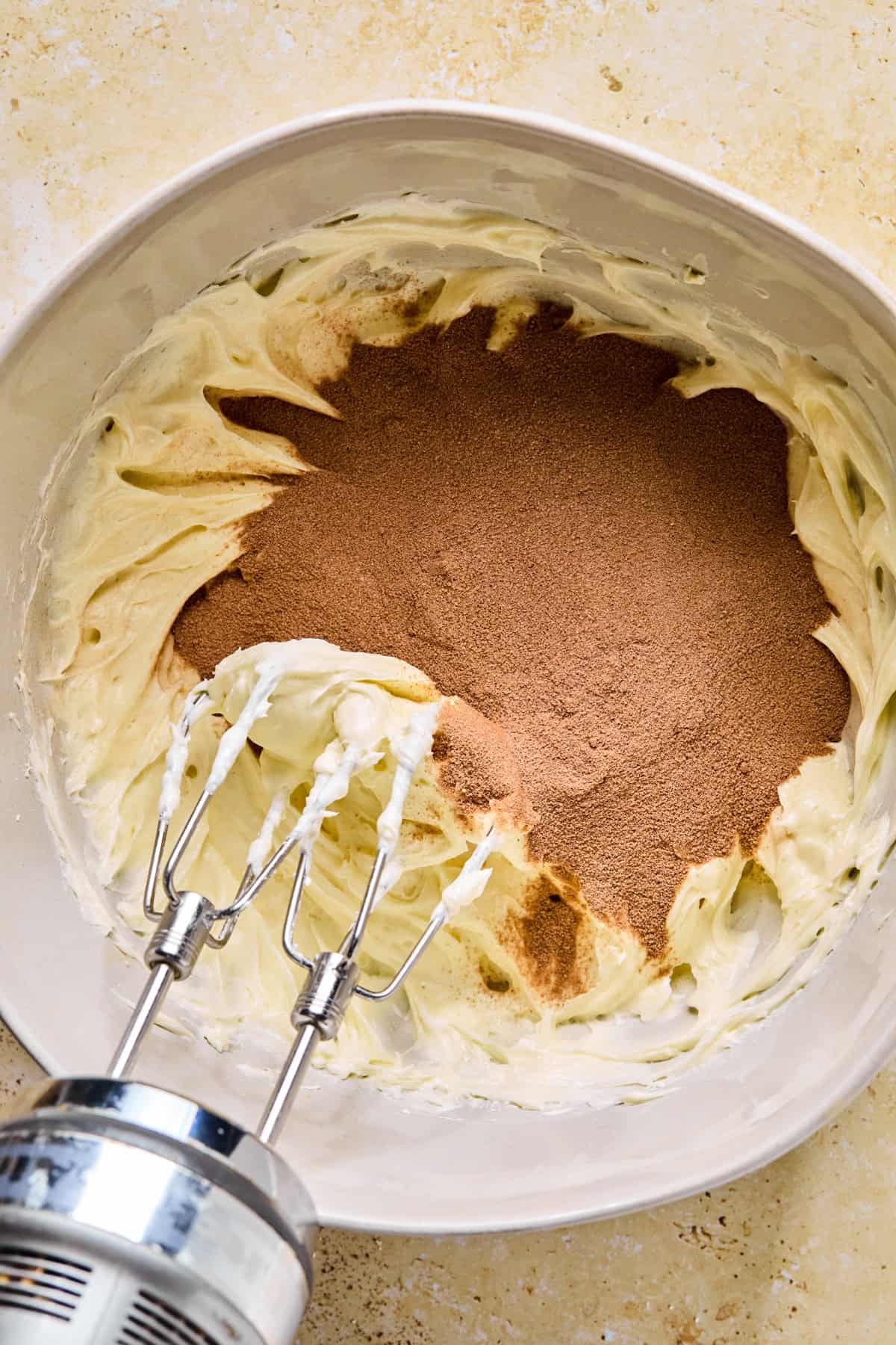 Cream cheese mixture in bowl with hot cocoa added.