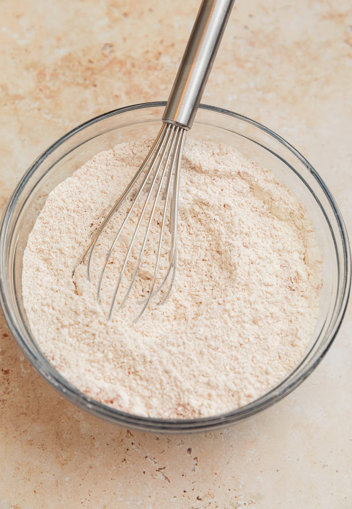 Whisked dry ingredients in glass bowl.