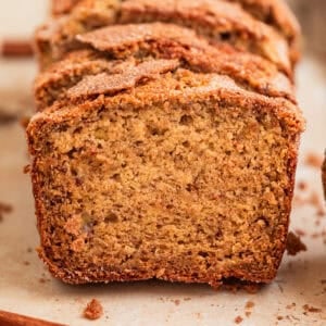 Cinnamon crunch topped banana bread propped up in a row.