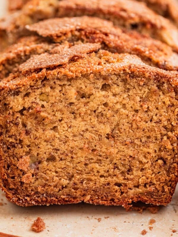 Cinnamon crunch topped banana bread propped up in a row.