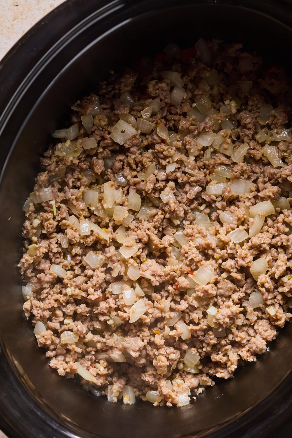 Italian sausage added to slow cooker.