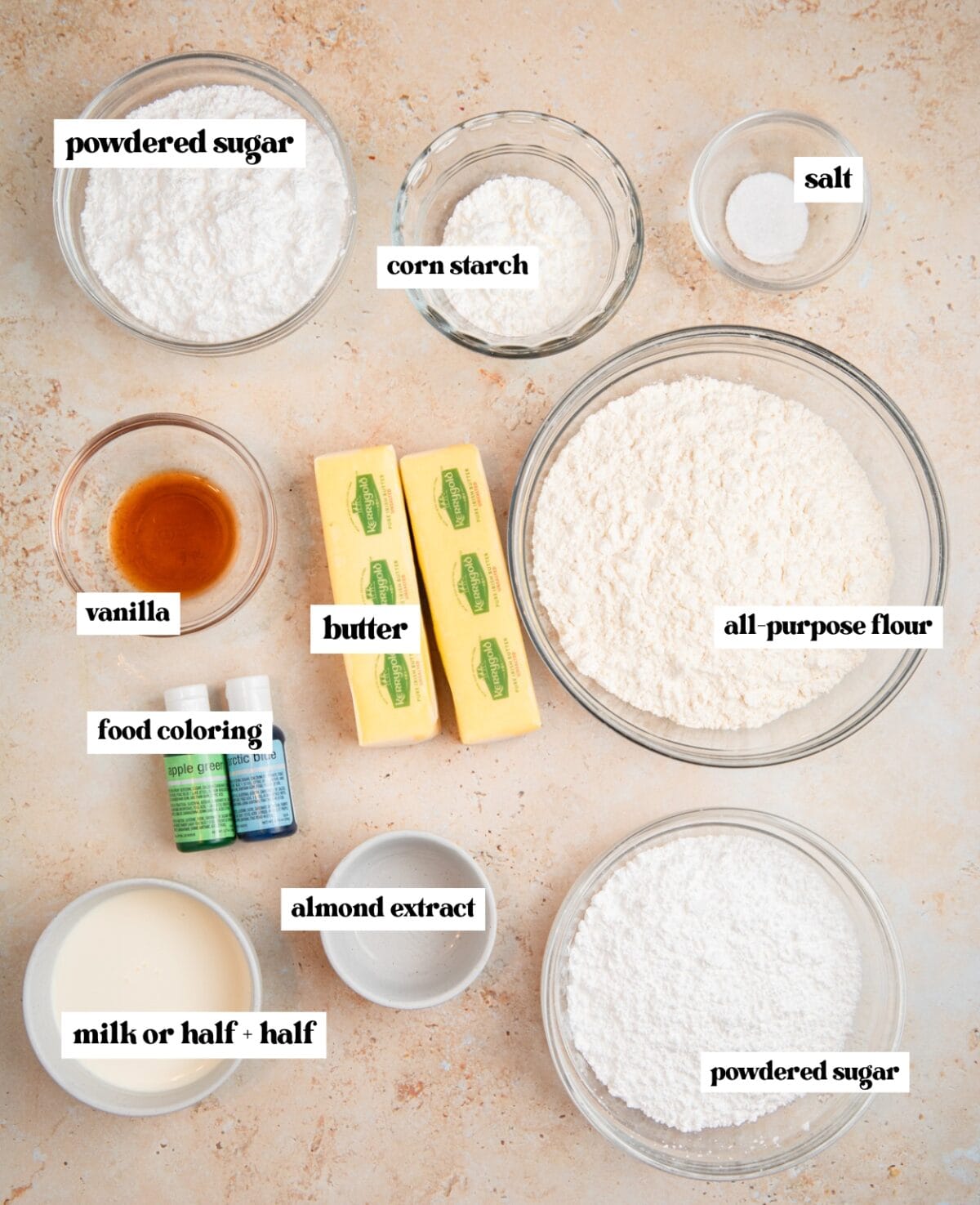 Powdered sugar, butter, flour and other ingredients labeled on surface.
