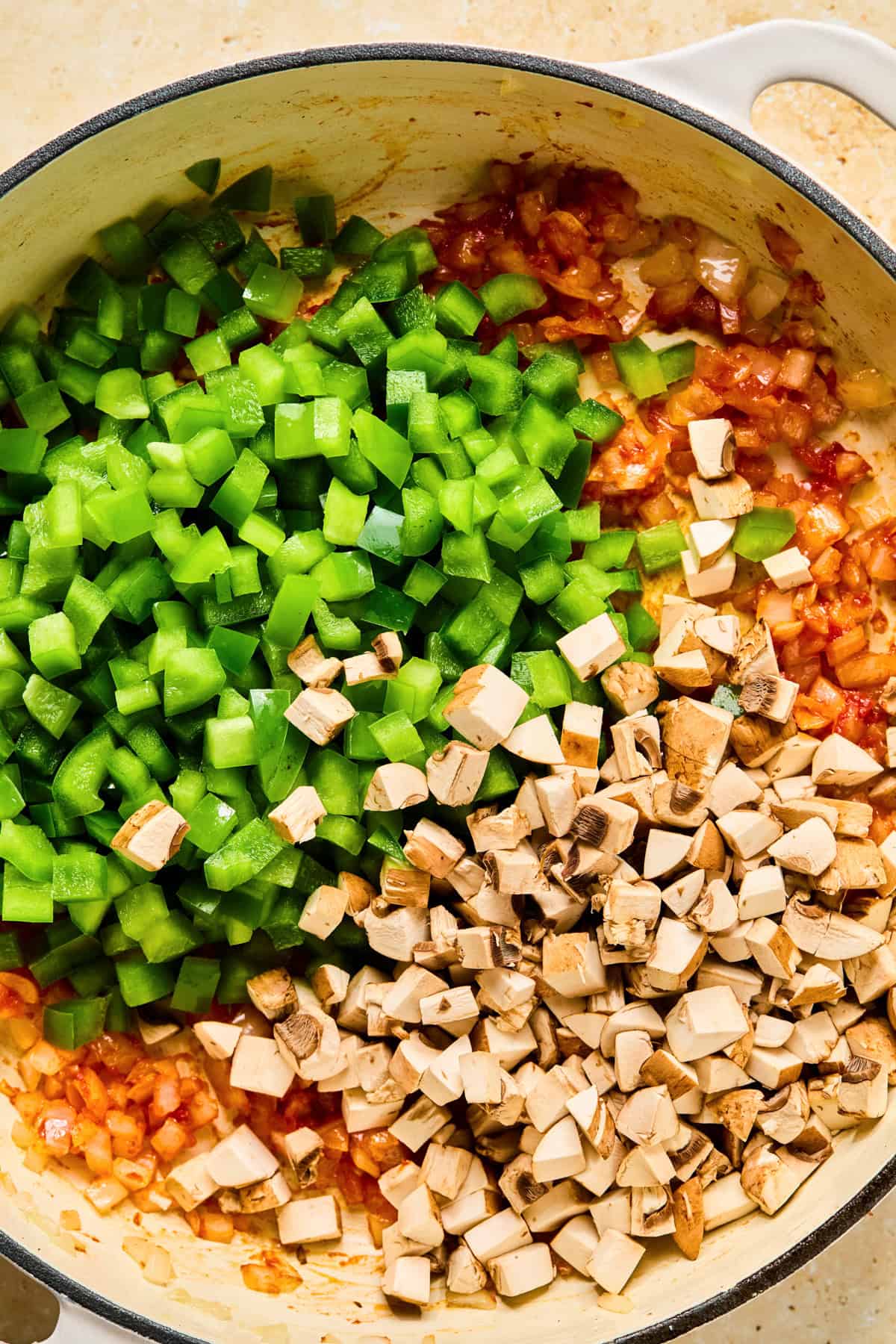 Green pepper, mushrooms and cooked onions in skillet.