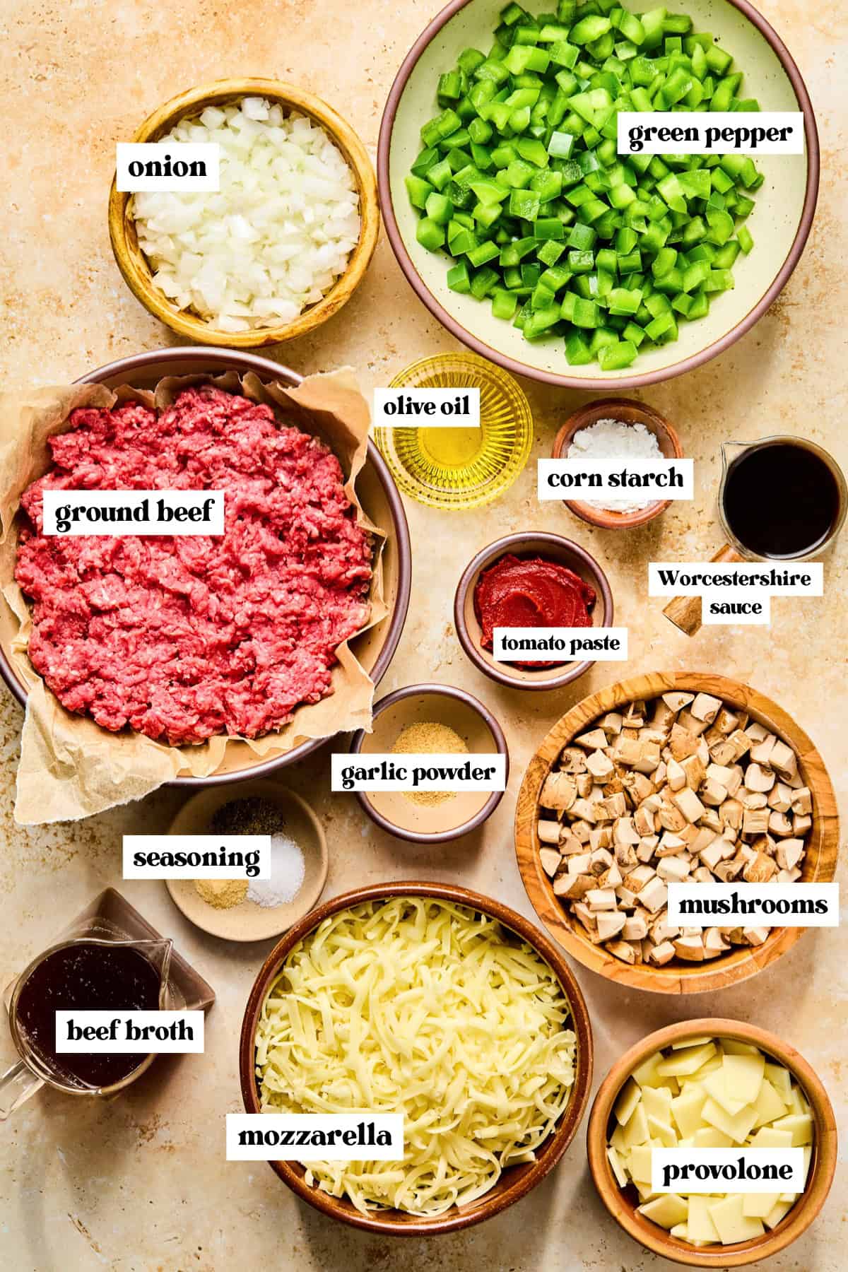 Chopped peppers, beef, cheeses and other ingredients needed for recipe.