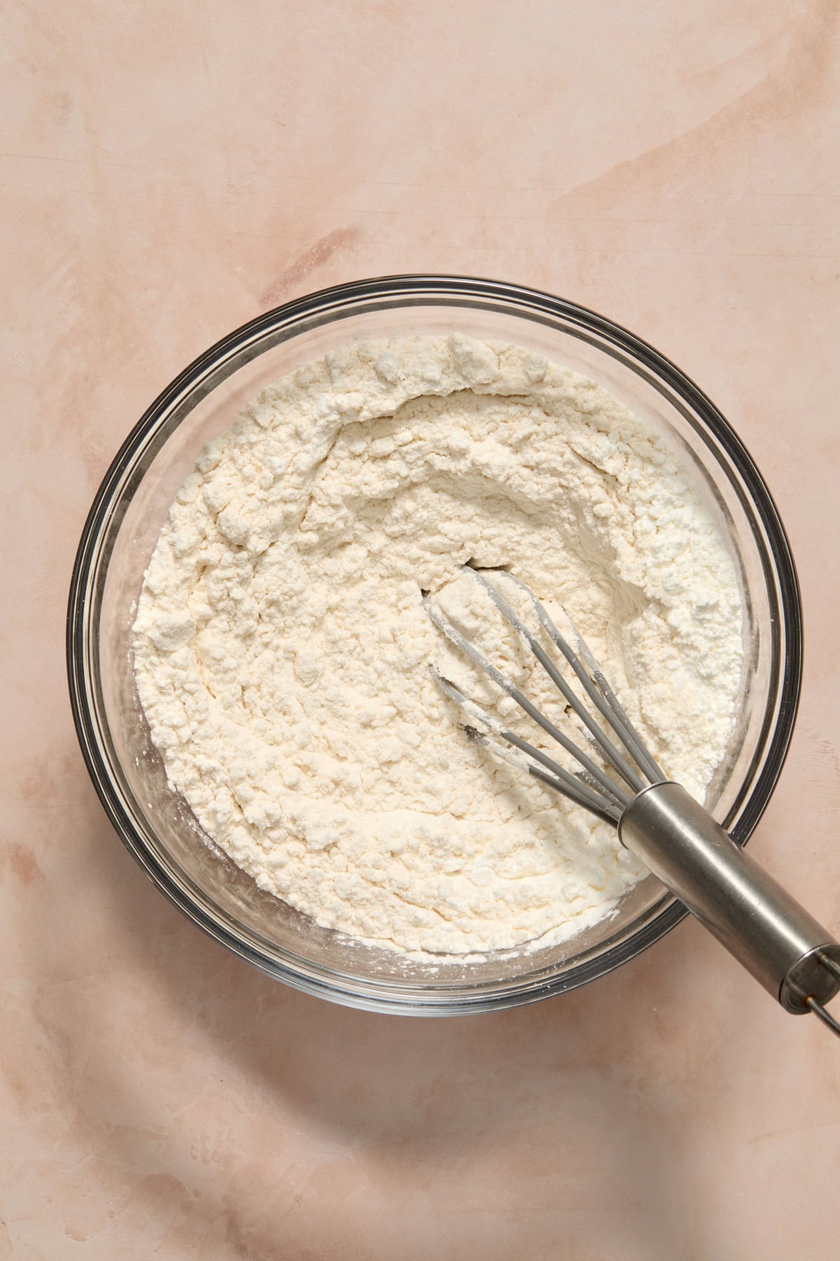 Dry ingredients in bowl with whisk.