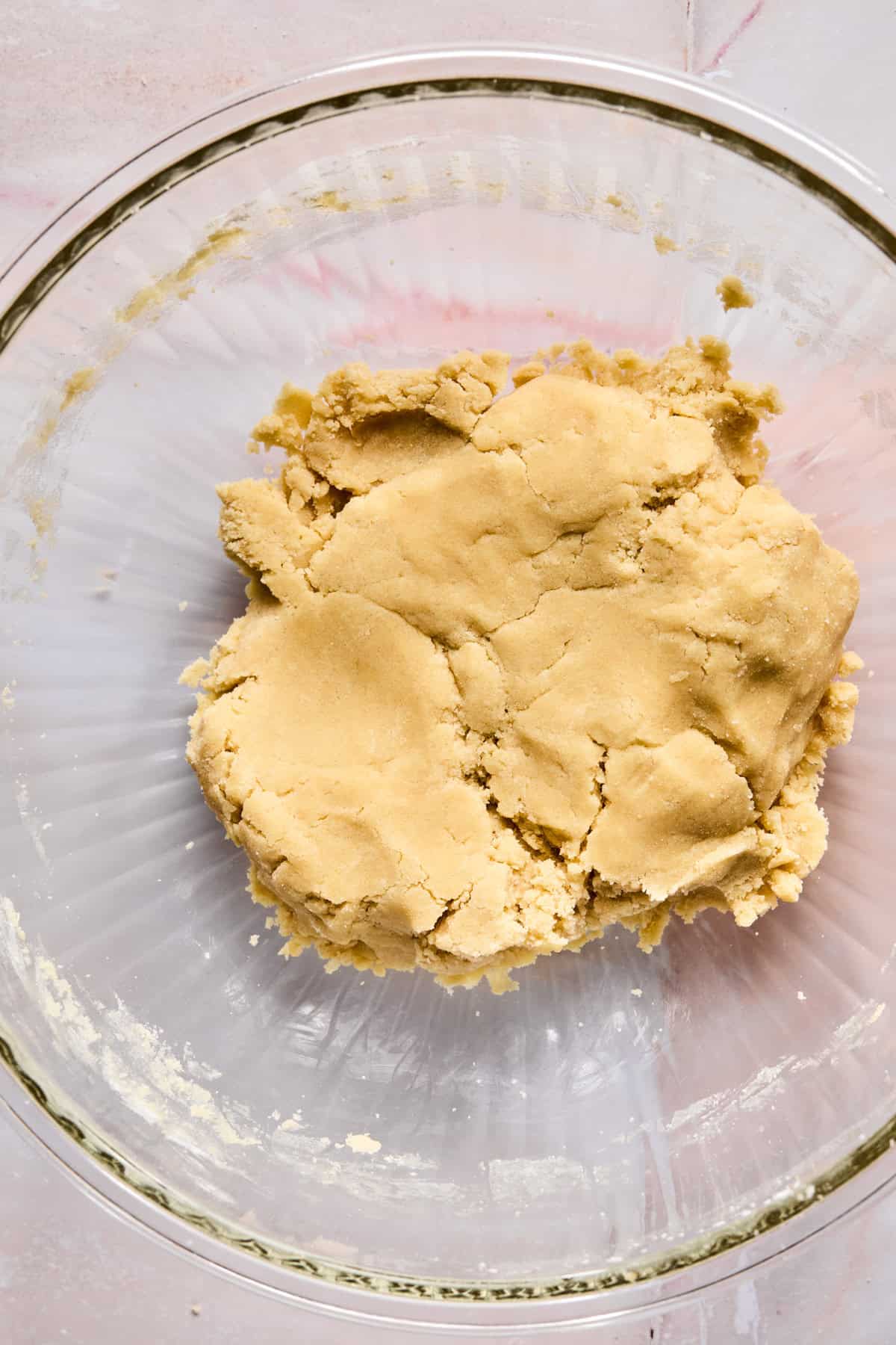 Sugar cookie dough in glass mixing bowl.