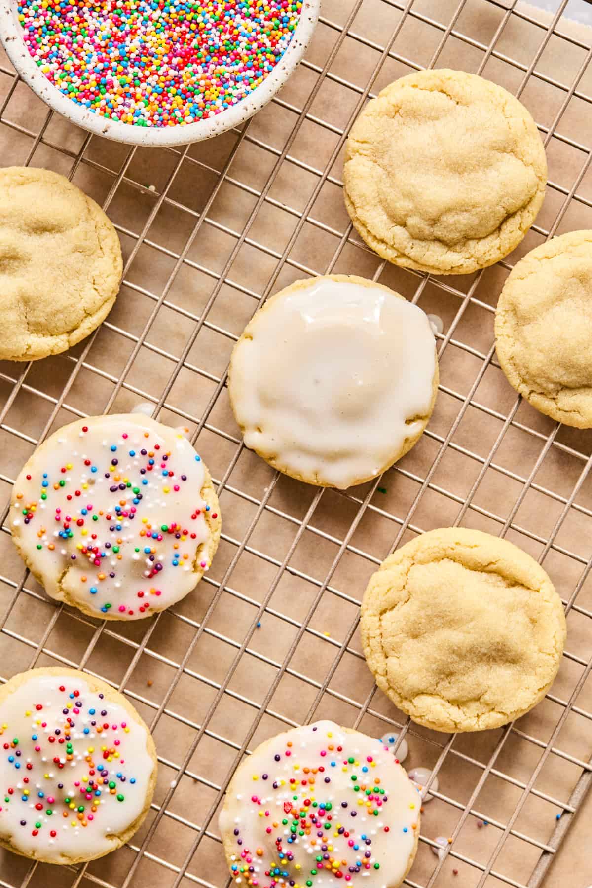 Sugar cookies on cooling rack with icing glaze.
