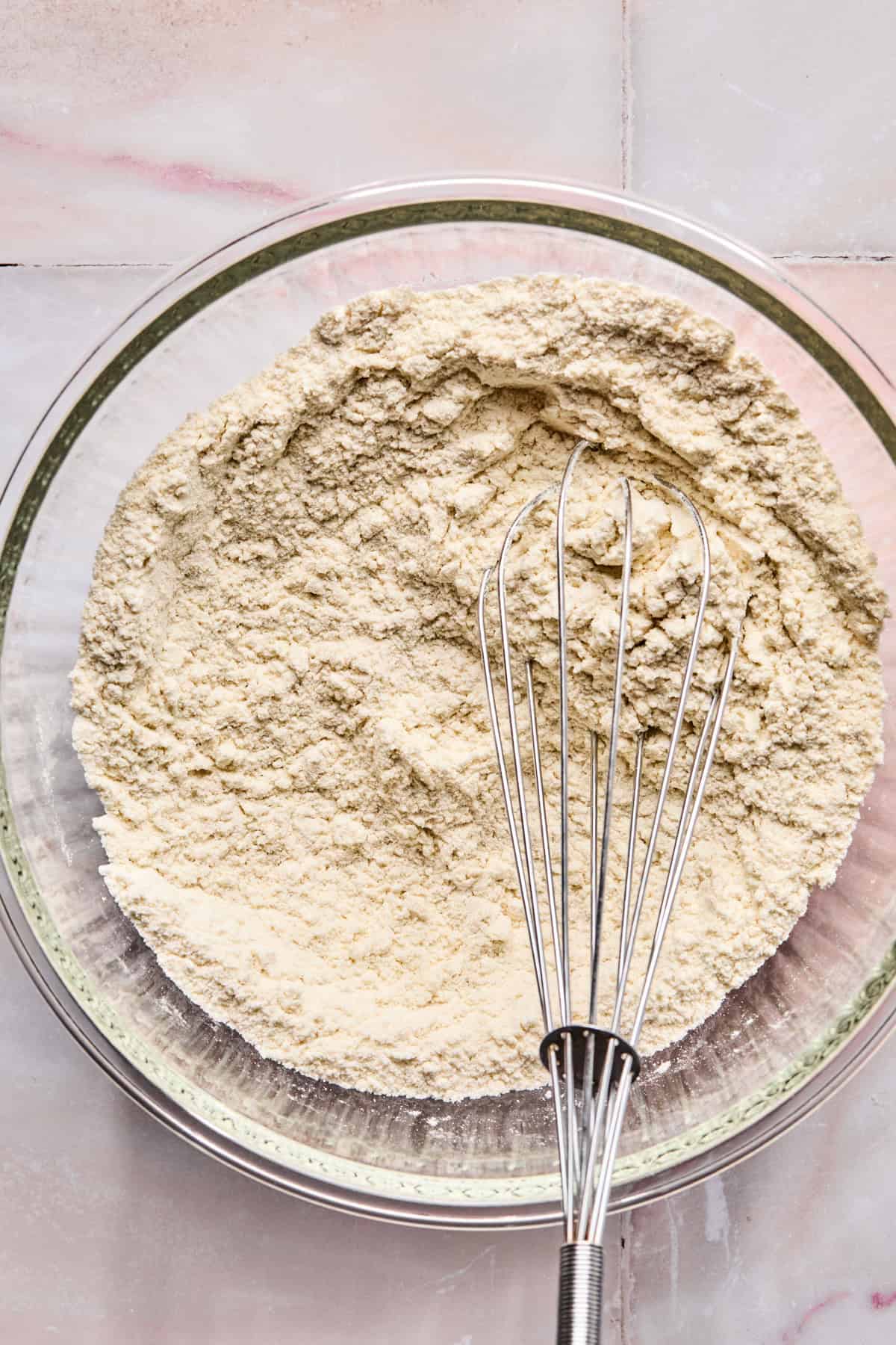 Dry ingredients whisked together in bowl with whisk.