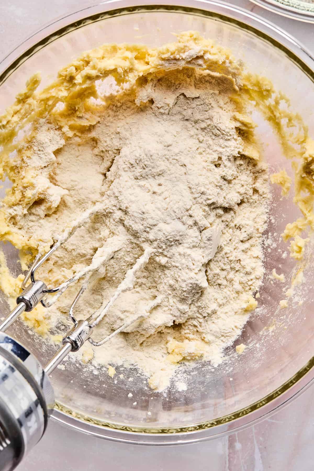 Dry ingredients added to wet ingredients in bowl.