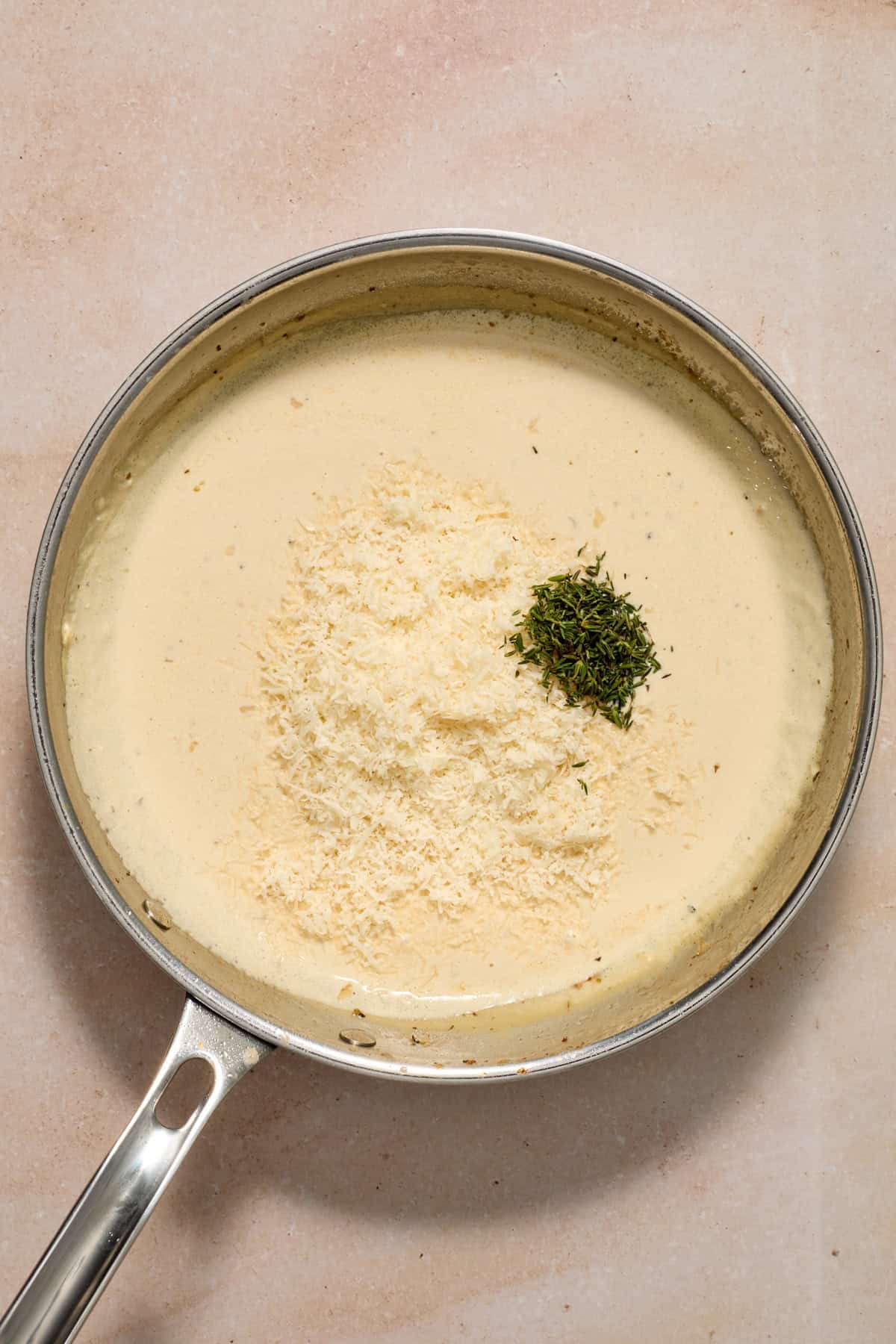 Parmesan and seasoning added to pan.