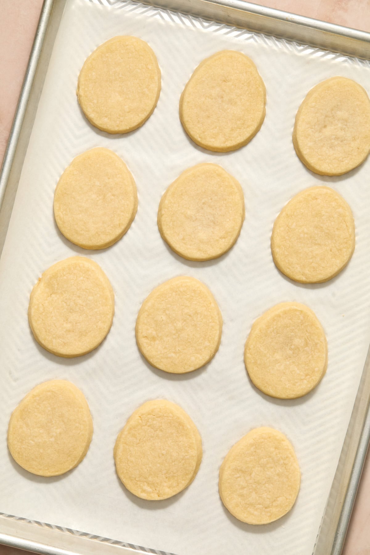 Baked Easter egg shortbread cookies on pan.