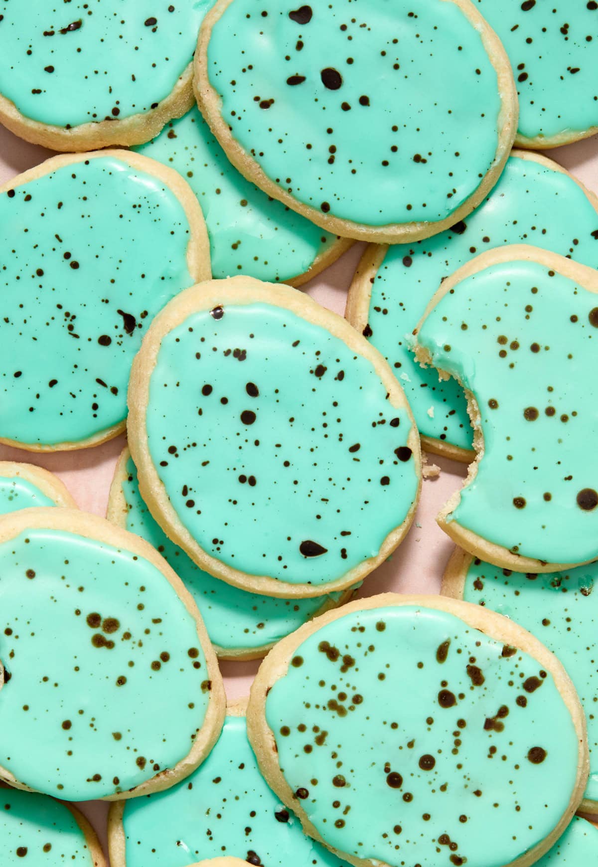 Speckled robin egg Easter egg shortbread cookies on surface.