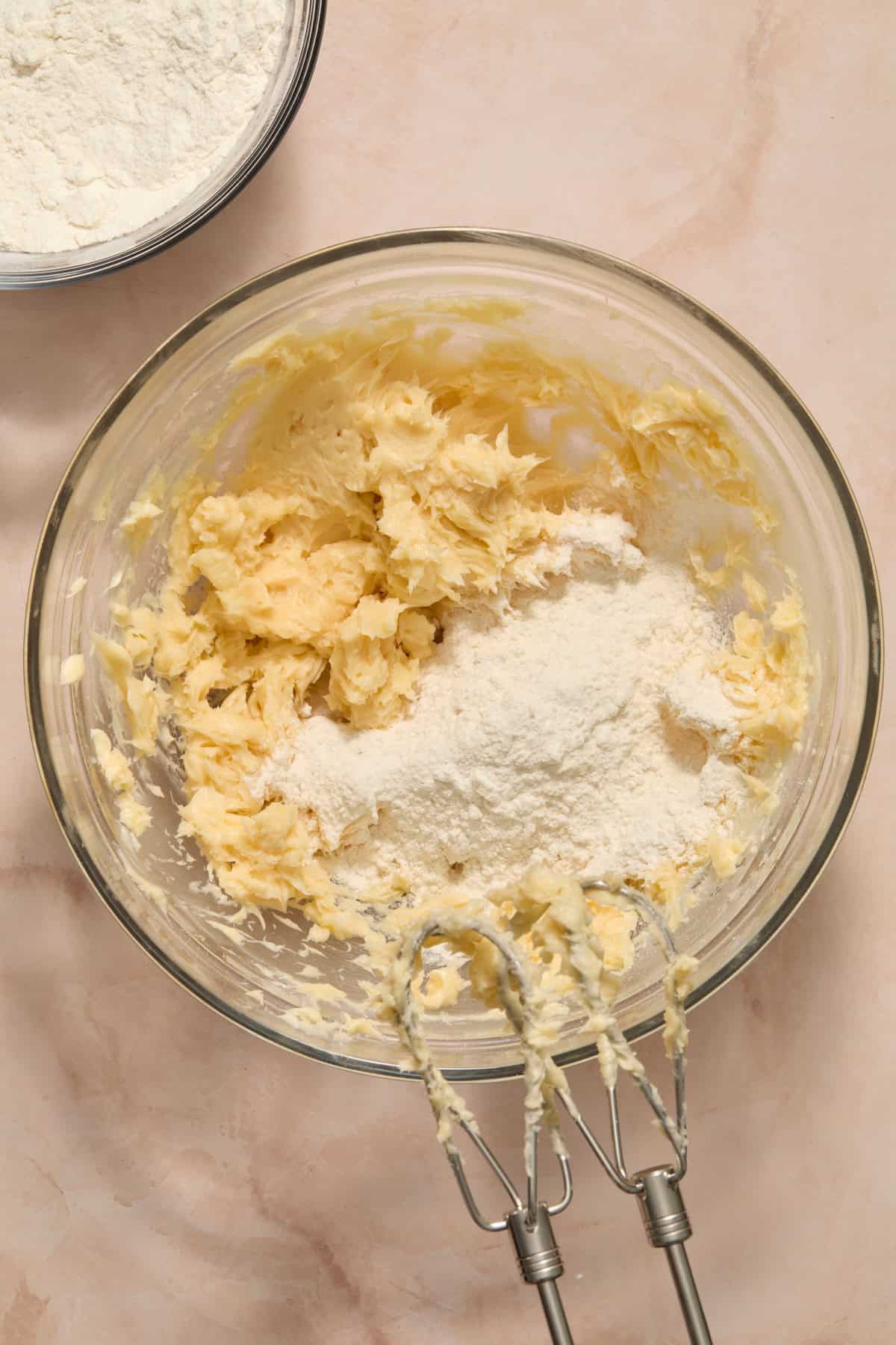 Dry ingredients being added to wet ingredients in bowl.