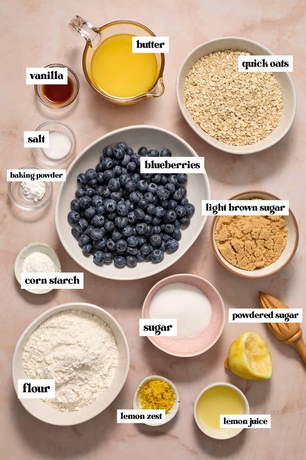 Blueberries, quick oats, sugars, lemon and other ingredients labeled on surface.