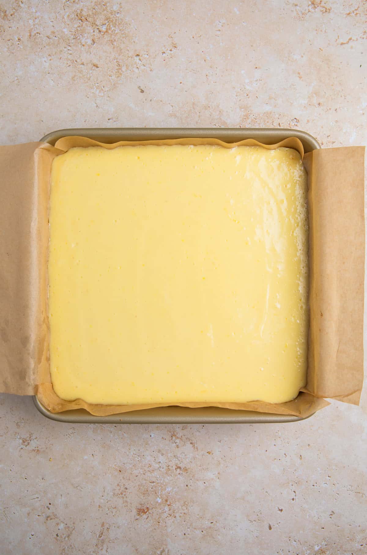 Baked lemon bars with graham cracker crust in pan.