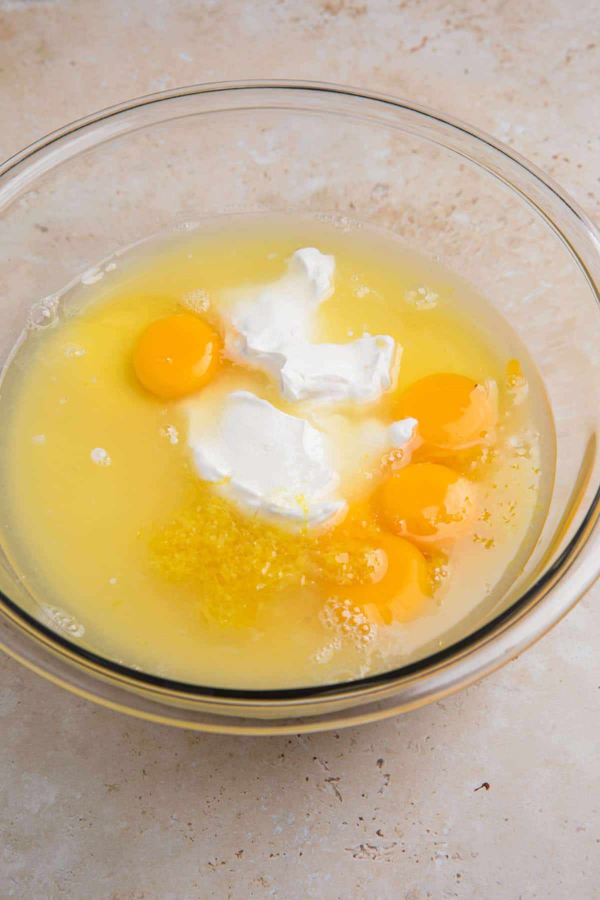 Eggs and egg yolks, sour cream, lemon juice, condensed milk and other ingredients in large bowl.