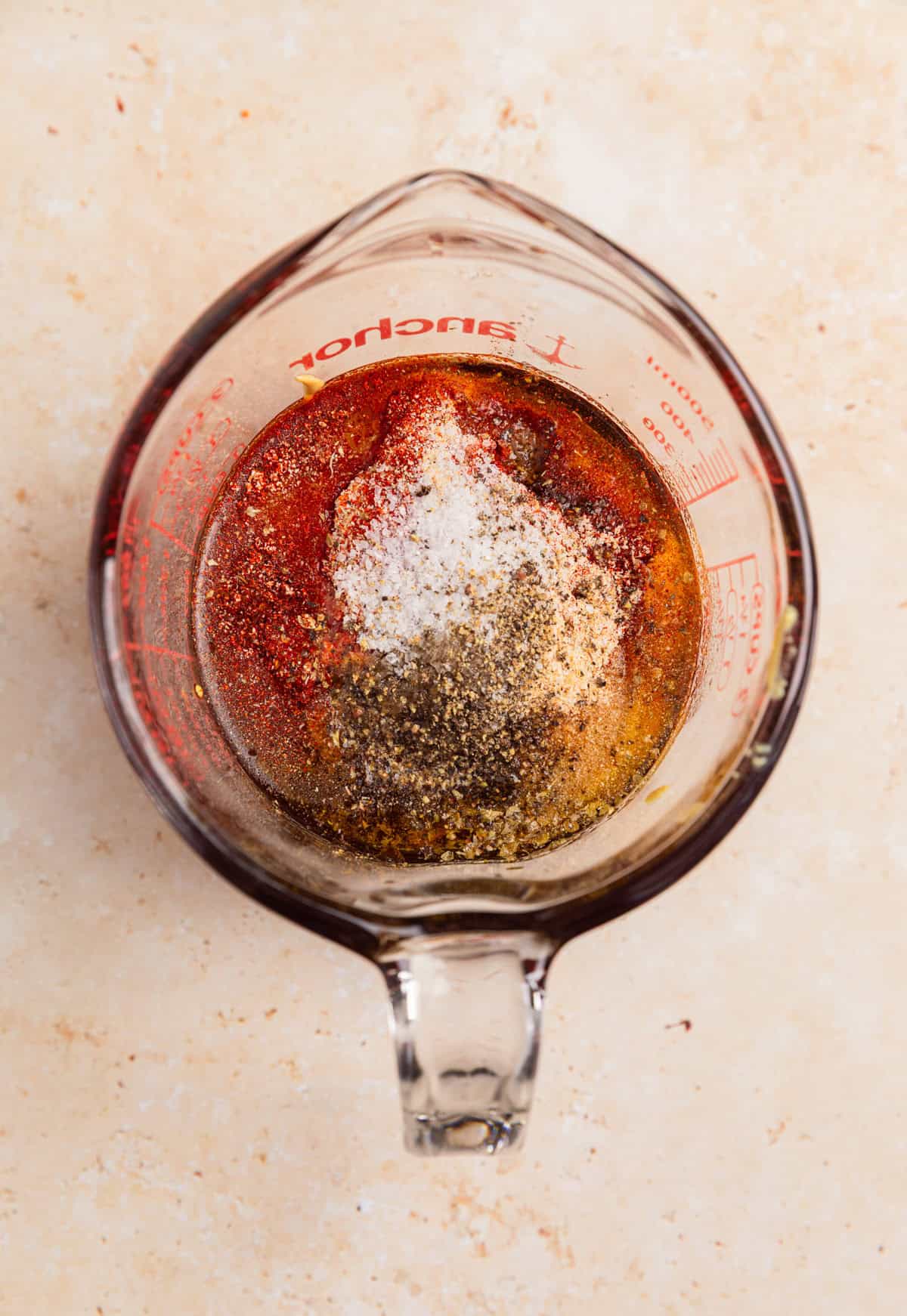Ingredients in measuring cup to make honey mustard marinade.