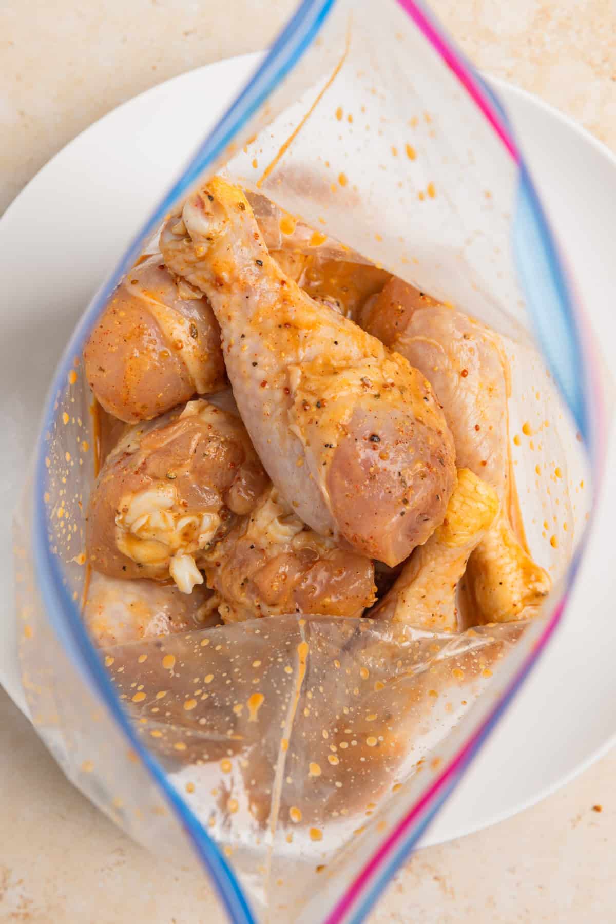 Marinated chicken legs in bag.