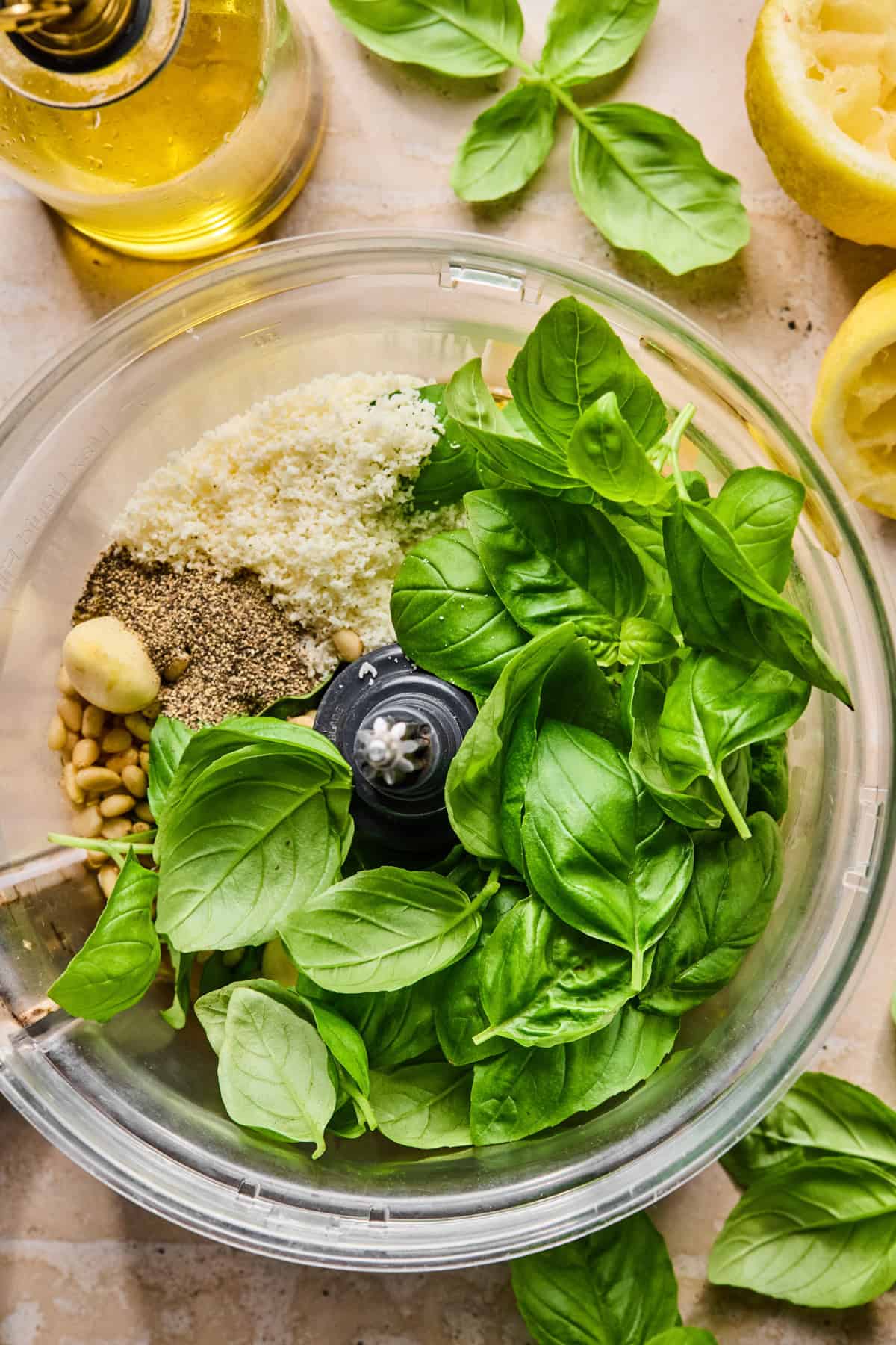 Basil, garlic, parmesan and other ingredients in food processor.