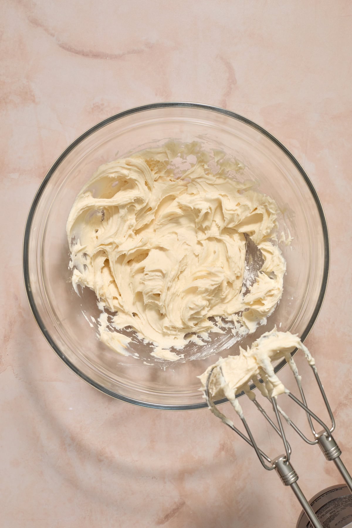 Cream cheese, powdered sugar and vanilla mixed in bowl.