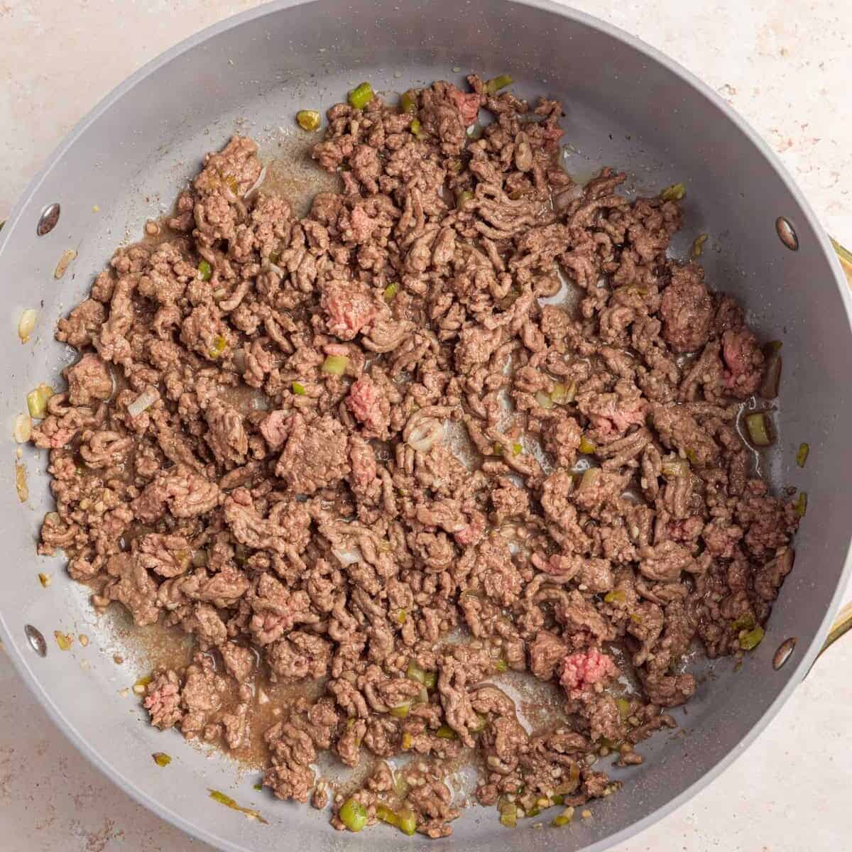 Ground beef browned in skillet.