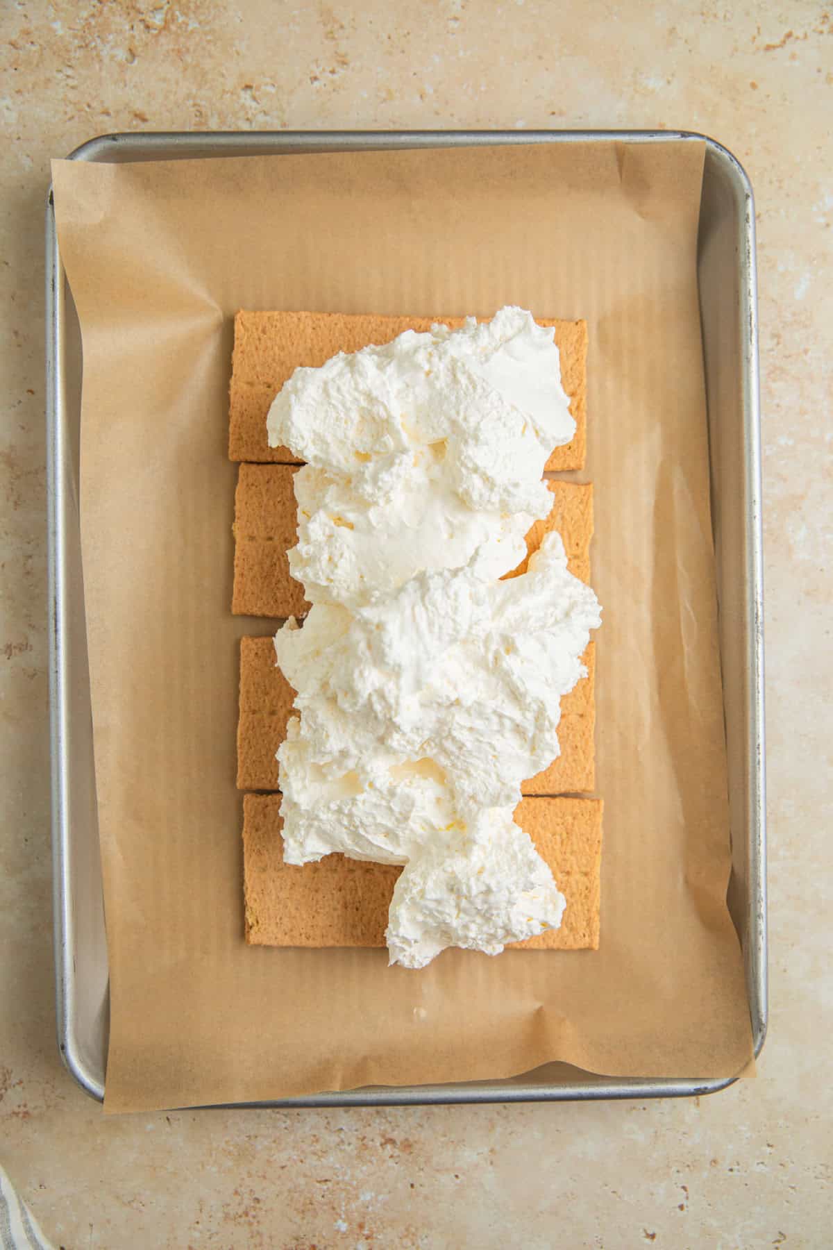 Graham cracker sheets with whipped topping over top.