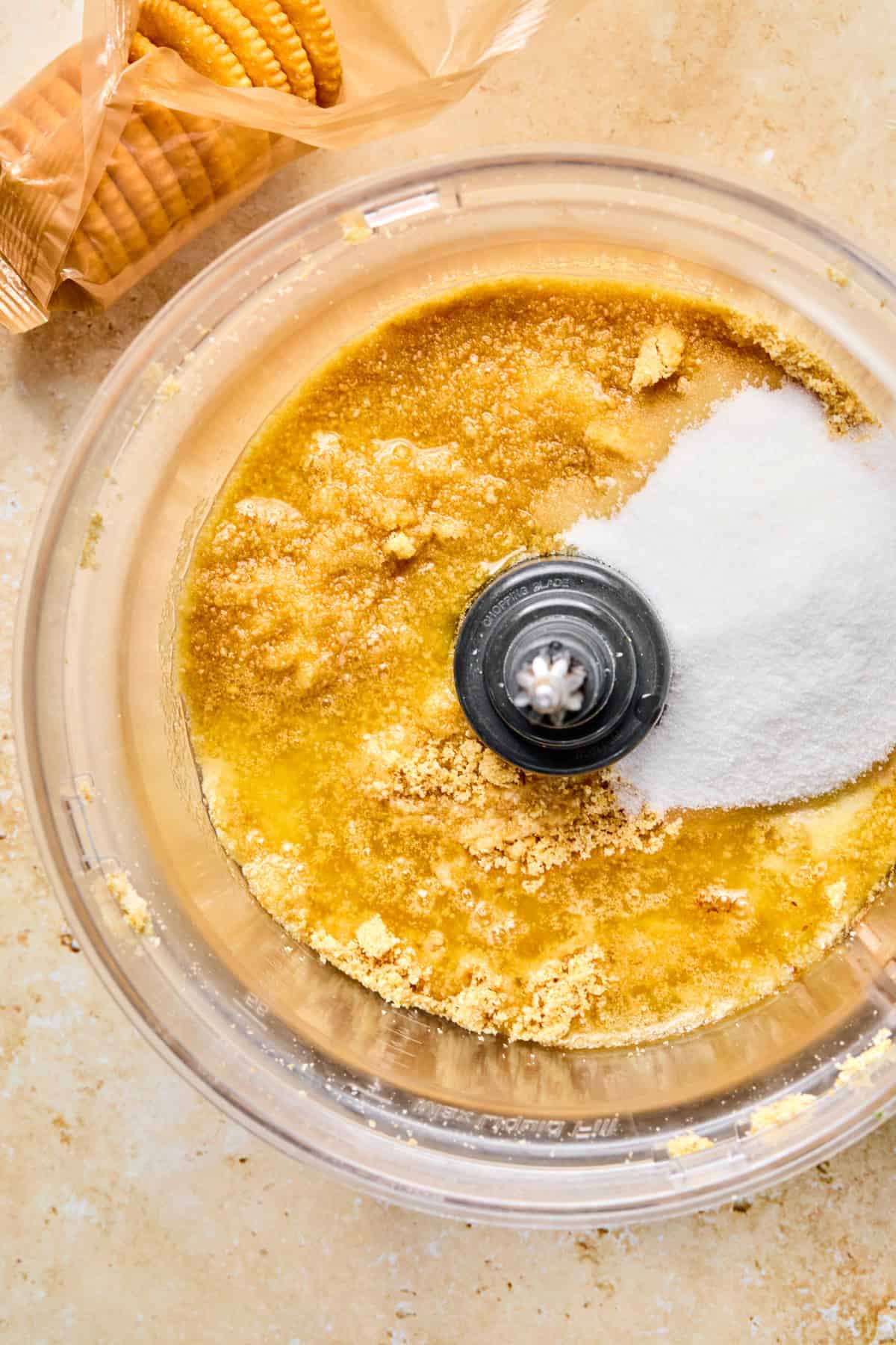 Crushed ritz crackers in food processor with sugar and butter.