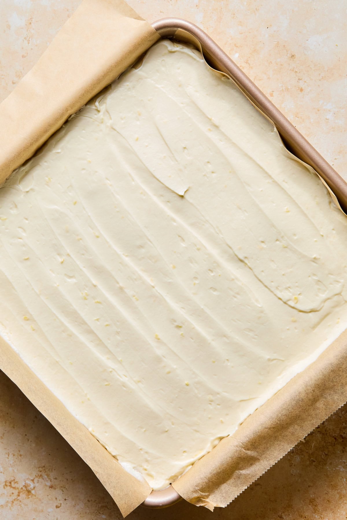 No-bake lemon cheesecake in pan spread evenly.