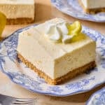 Piece of lemon cheesecake bar on plate.