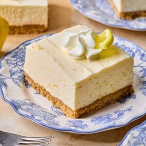 Piece of lemon cheesecake bar on plate.